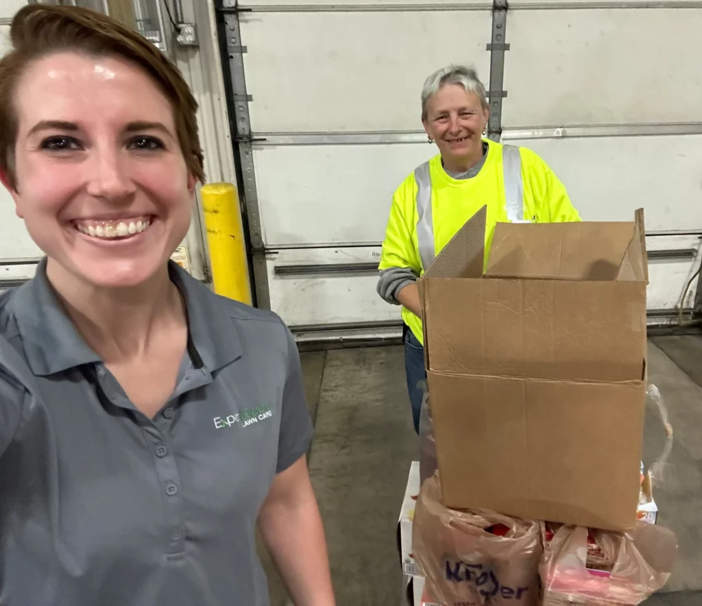 ExperiGreen employees packing food donation boxes for a local food bank