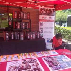 close up of a woman under a red tent with a home4me booth full of brochures and pictures