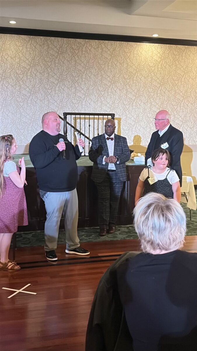 Chicago sales manager speaks and presents donation.