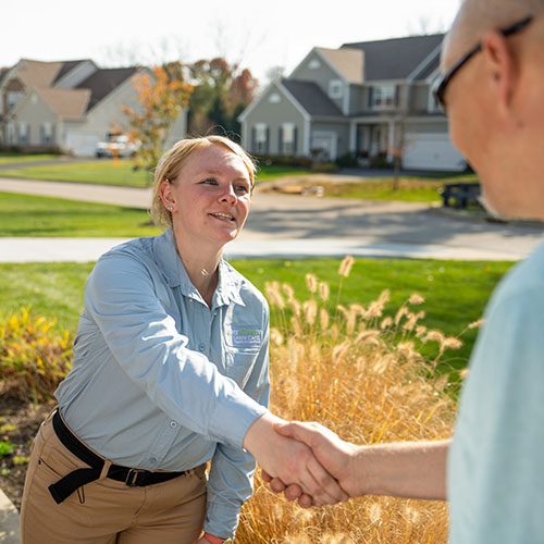 Lawn technician shaking customers hand