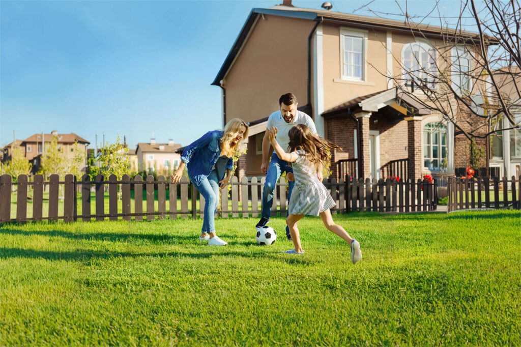 family playing in green lawn