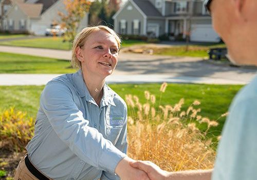 Technician & Customer Lawn technician shaking customers hand